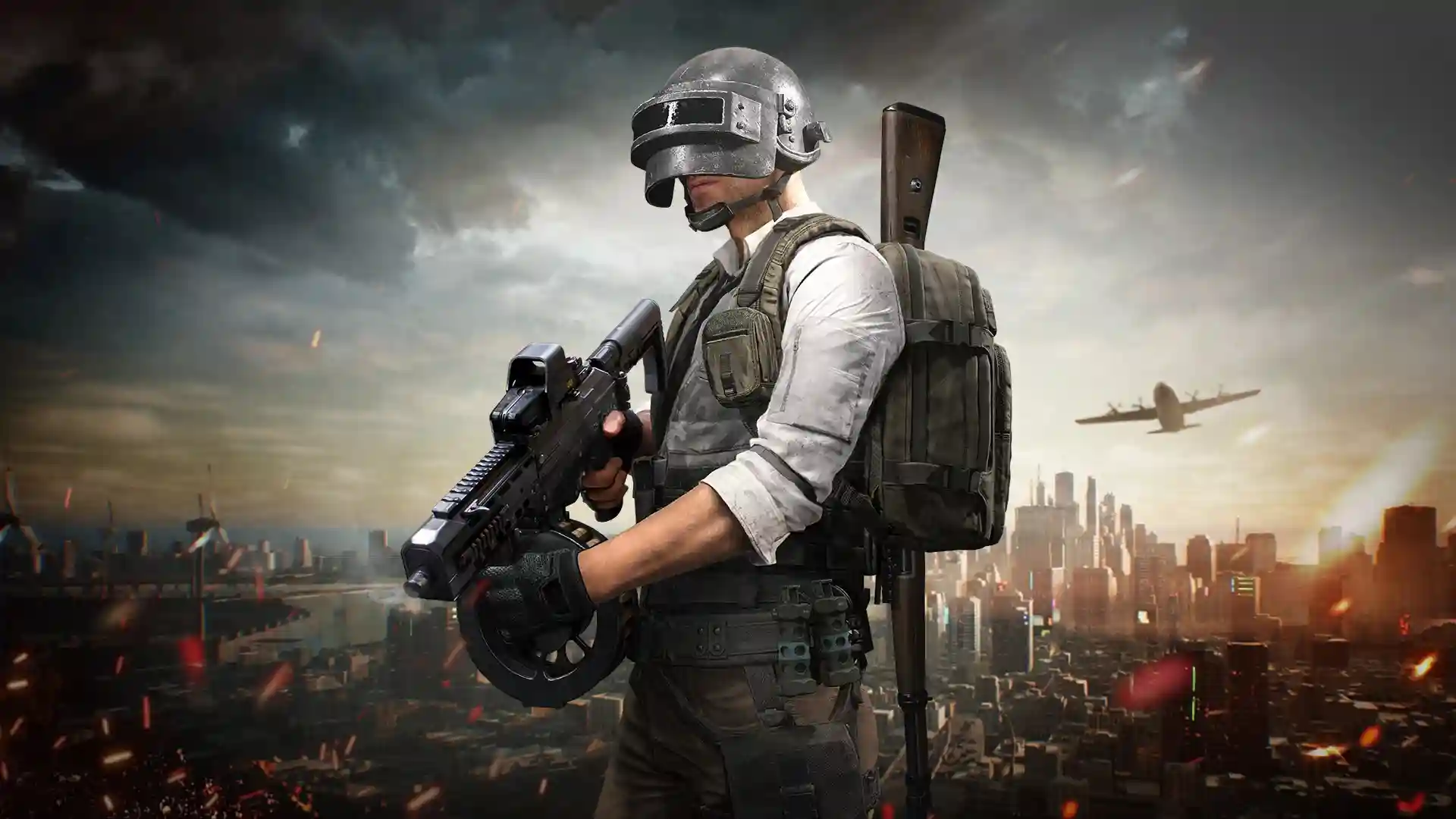 Tactical battle royale character wearing a military helmet and armored vest, holding an assault rifle with a backpack and scope-mounted rifle strapped to his back, overlooking a dystopian city skyline at sunset with a cargo plane flying overhead